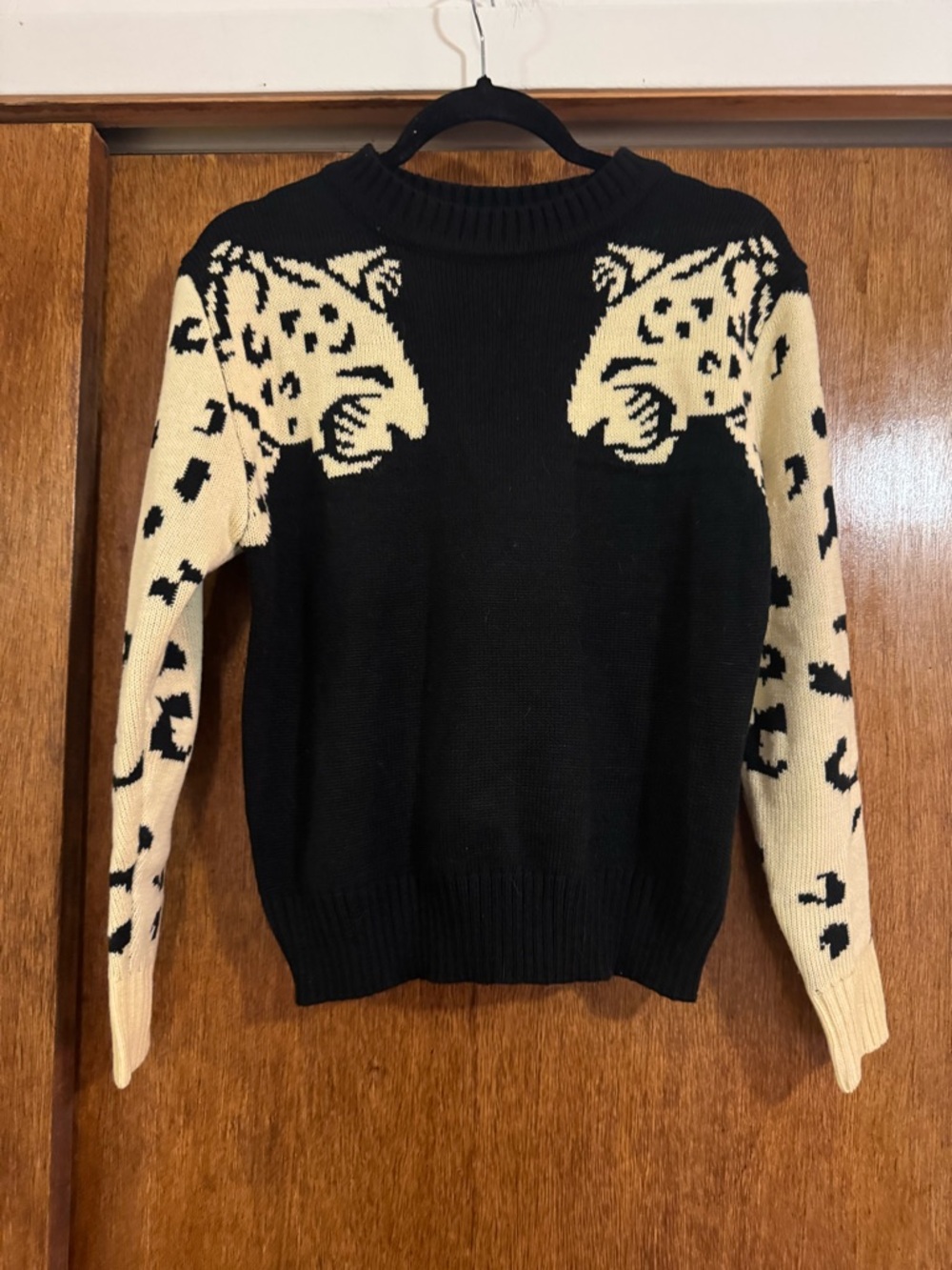 black sweater with leopard sleeve detail